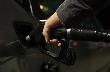 man pumping gas into car