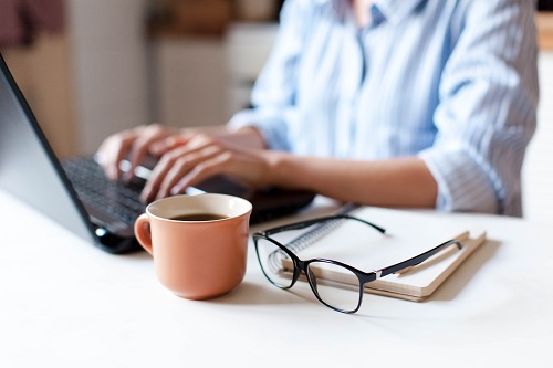 woman typing on laptop